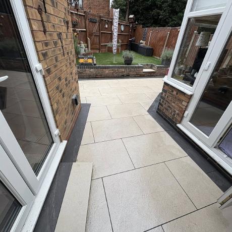 Cream porcelain patio with charcoal border outside French doors in Kingswinford