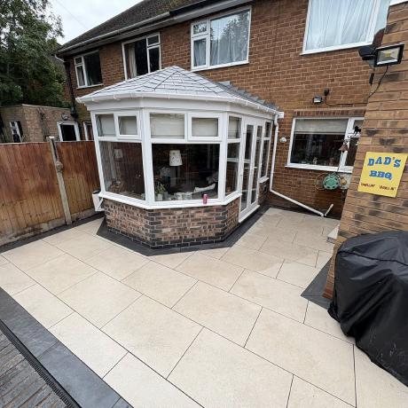 Cream porcelain patio paving laid around a conservatory