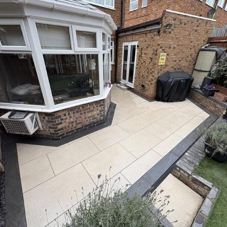 Cream porcelain patio with charcoal edging and sunken garden steps