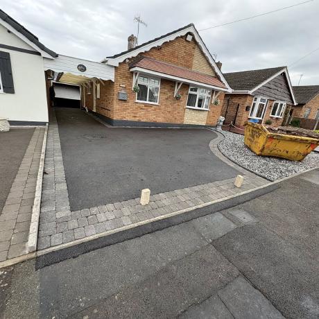 Tarmac driveway with block-paved border and gravel edging at a West Midlands bungalow
