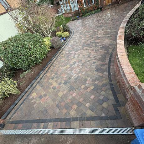 Block paving driveway with drainage channel viewed from above