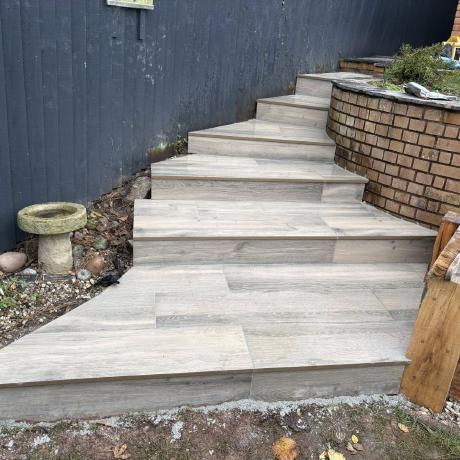 Wood-effect porcelain garden steps built on a sloped garden