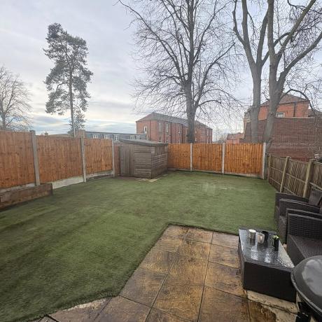 Artificial lawn, new fencing and patio in a landscaped rear garden