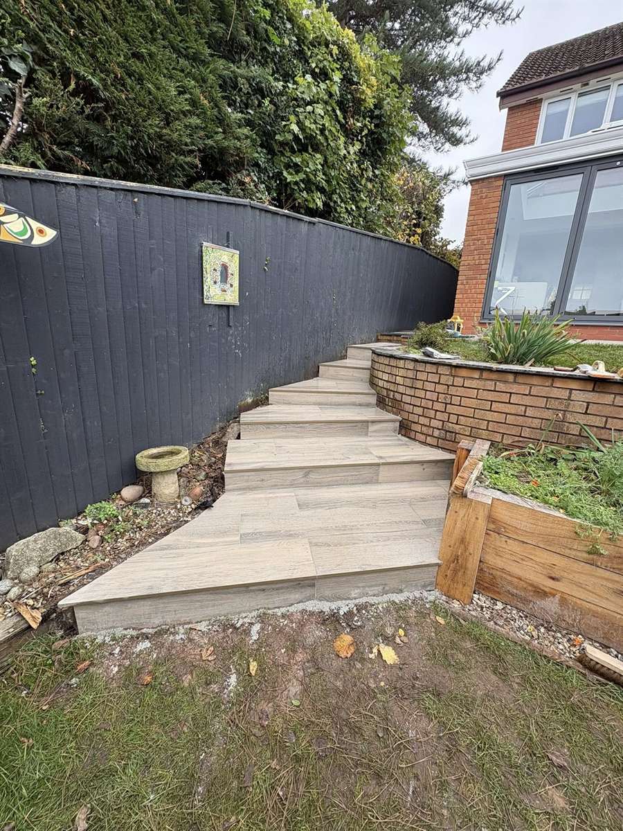 Porcelain garden steps and brick planter walls landscaped in Kingswinford