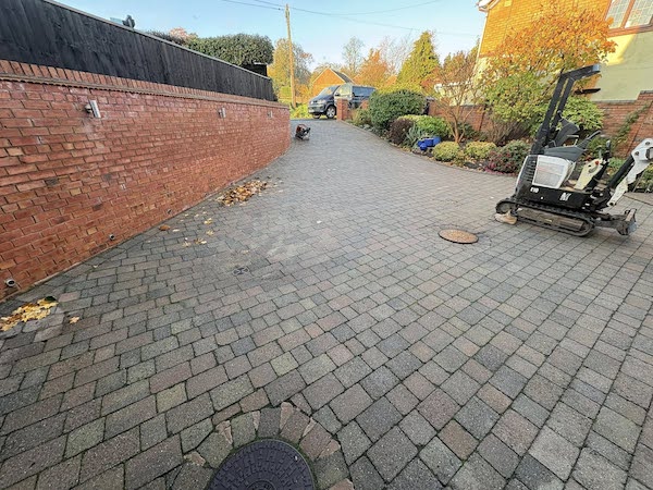 Newly laid block paving driveway in Kingswinford with brick boundary wall